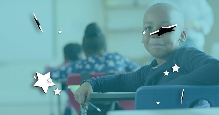 Boy sitting at school desk writing when teacher prompts, animated star shapes swirling around him