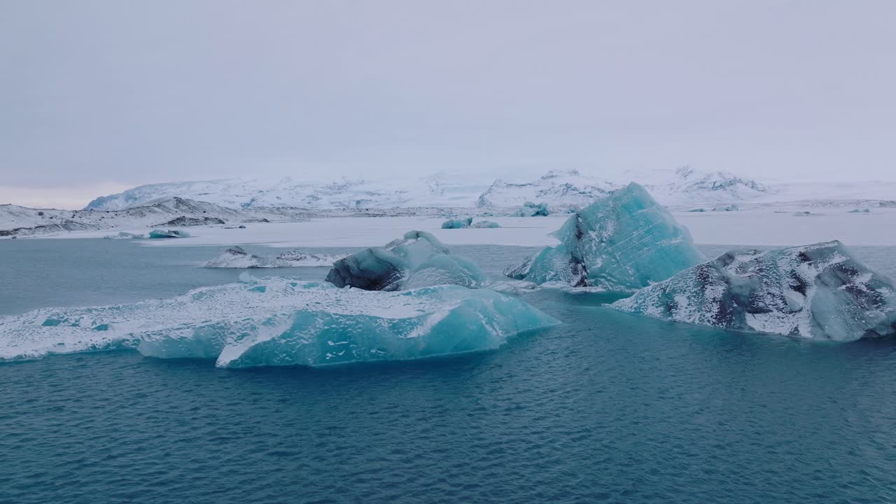 Aerial landscape view over icebergs in the glacial water of Jokulsarl&oacute;n lake, in Iceland, during winter