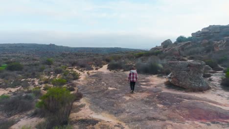 Man-walking-through-the-rock-formations-4k