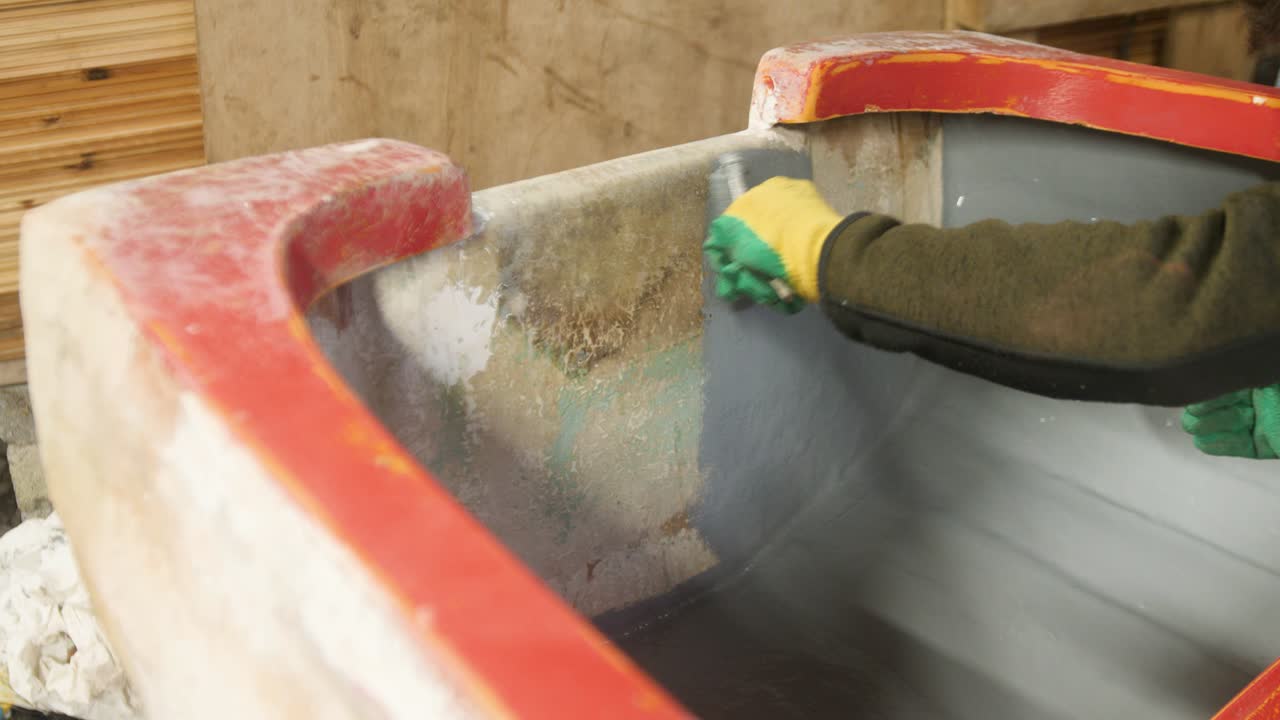 Painting fiberglass transom of fishing boat with roller