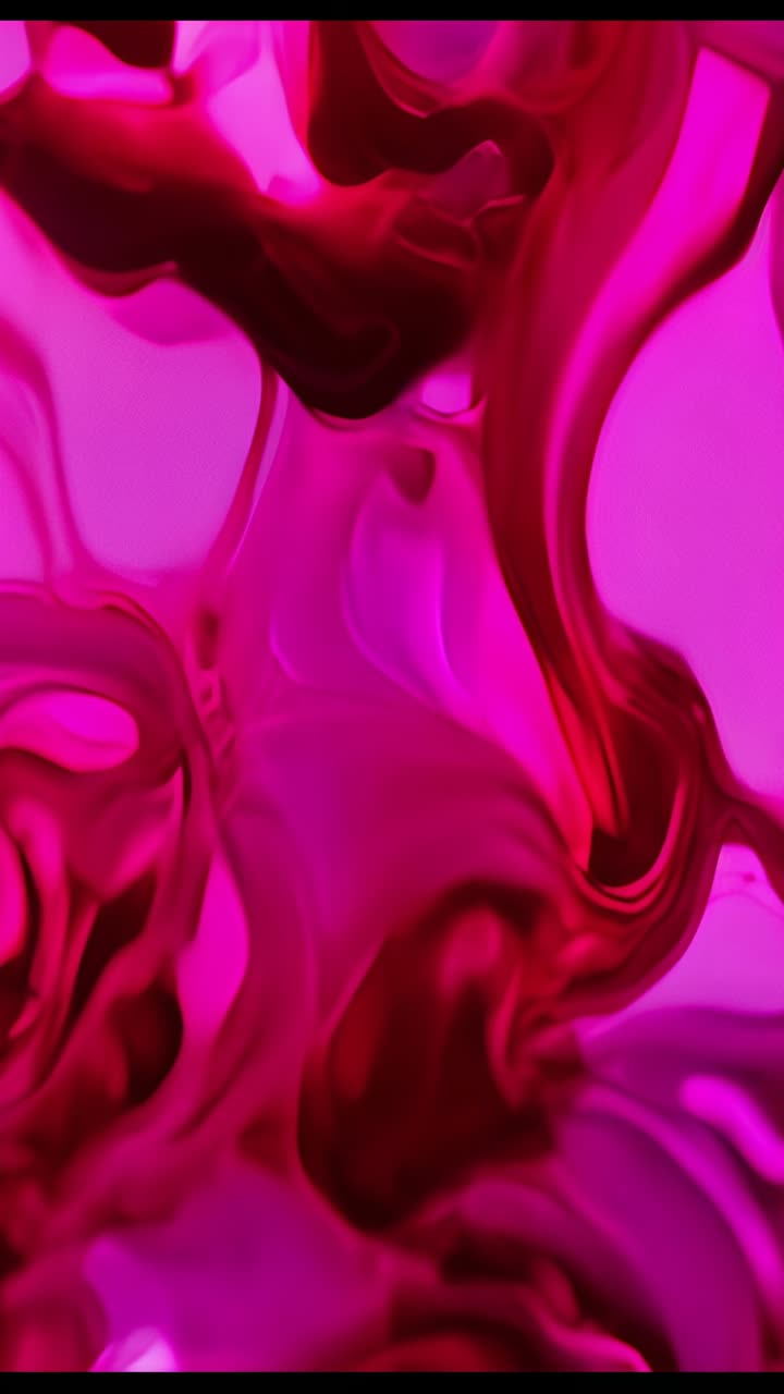 Vertical video: Injecting magenta fluid forming branching swirls in glass vessel under pink light