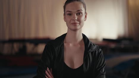 portrait of a young woman smiling in a gym