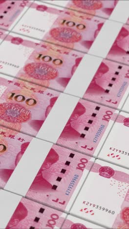 vertical video of 100 chinese renminbi banknotes printing by a money press