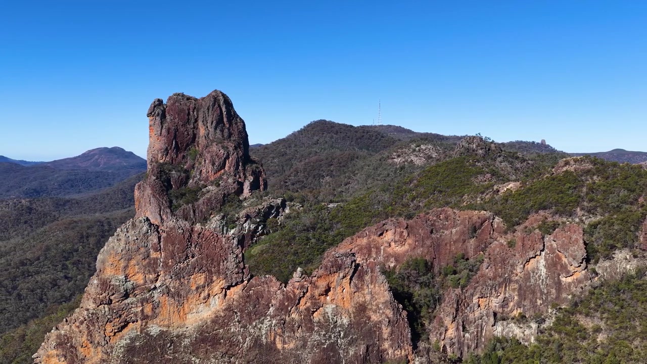 Inquadratura ampia della formazione rocciosa The Breadknife sotto un cielo azzurro sereno nel Parco Nazionale di Warrumbungle.