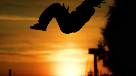 silhouette of person dancing at sunset