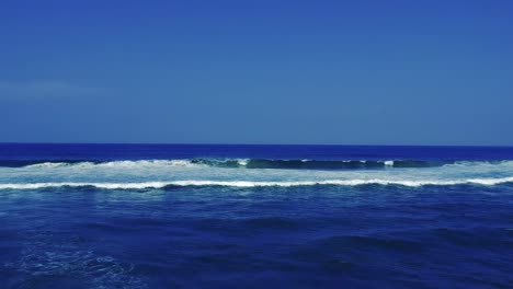 aerial footage filmed with a drone overlooking the beach and sea of crashing waves with a deep blue ocean on the bluff in africa southern hemisphere