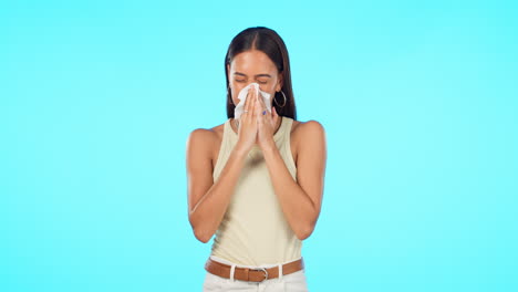 tissue, blow nose and woman isolated on a blue