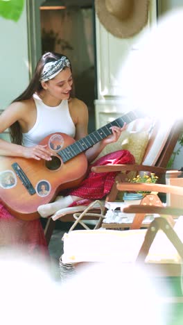 woman playing guitar outdoors in a camper van