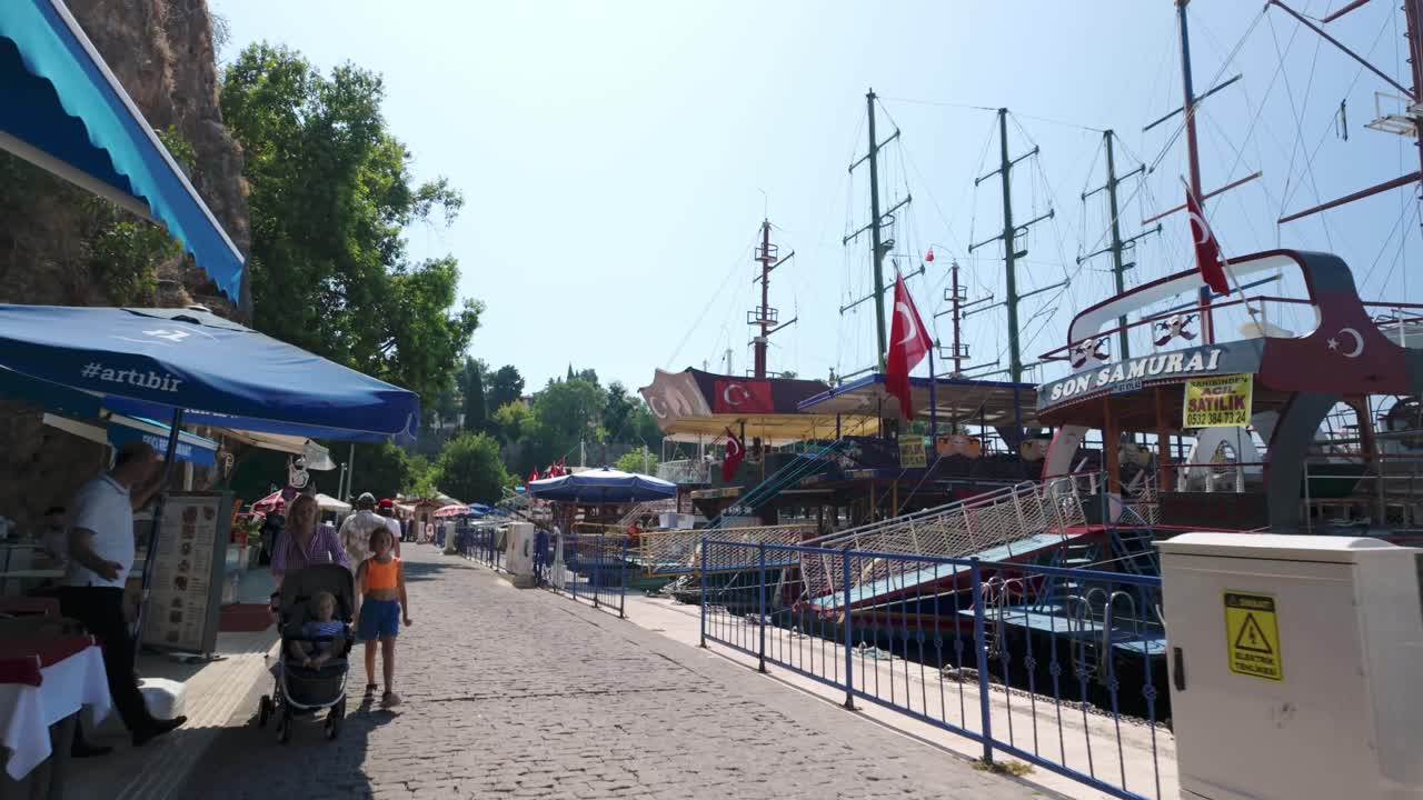 Exploring Antalya's marina on a sunny morning, with boats docked along the pier