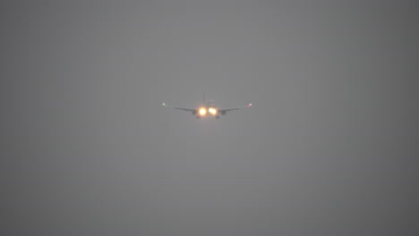 a plane flying in the gloomy sky