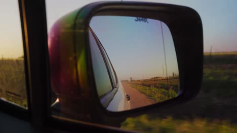 driving on a country road at sunset