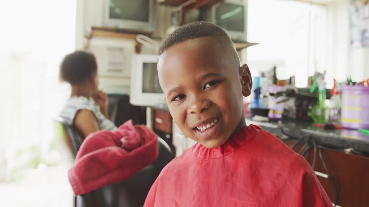 African boy smiling after hair cut