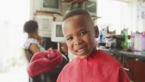 african boy smiling after hair cut