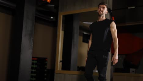 Male-at-gym-stands-from-the-floor-without-help,-kick-up