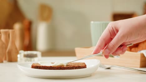 woman spreading butter on bread