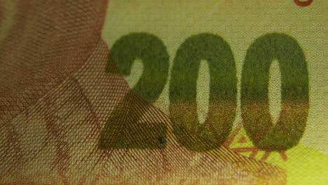 this is the macro view of a normal paper banknote- money- currency of 200 south african rand