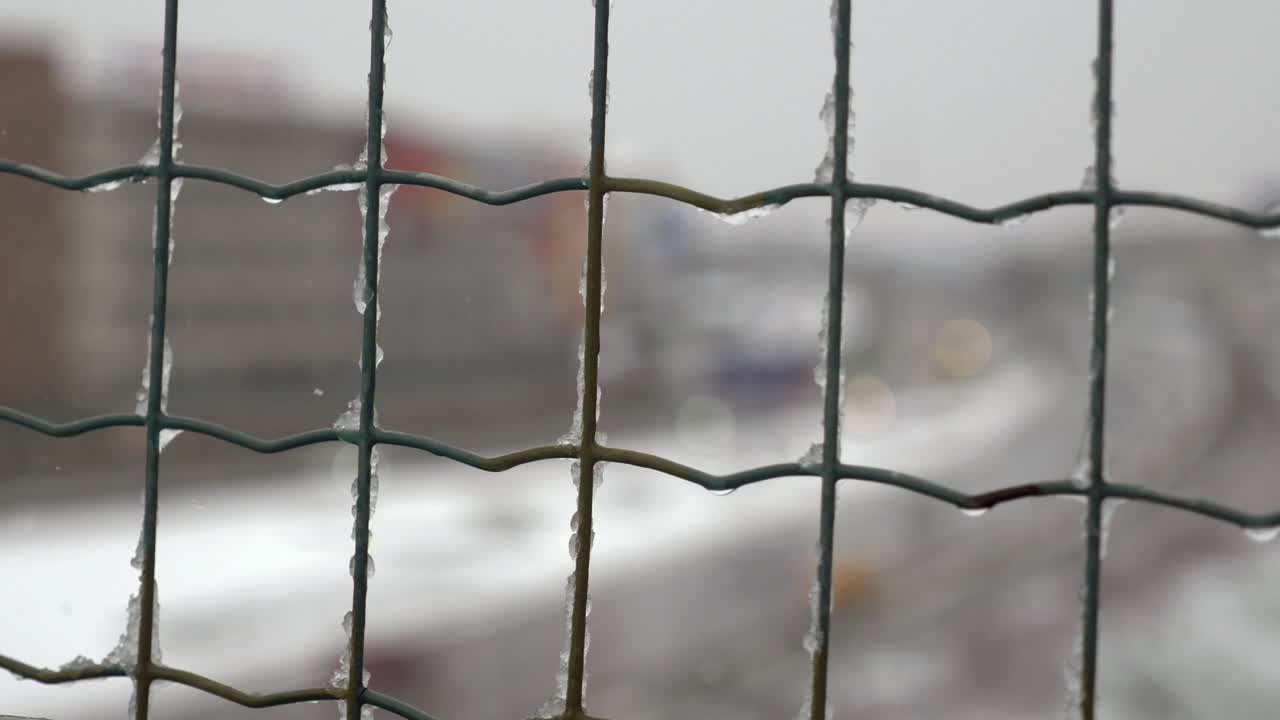 Close-up of a wire fence covered in ice and snow