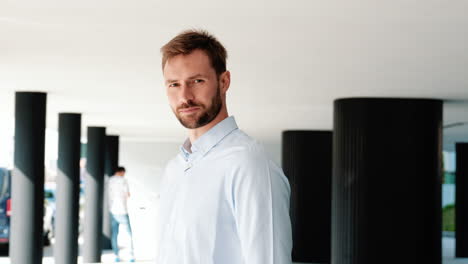 portrait of a man in a light blue shirt