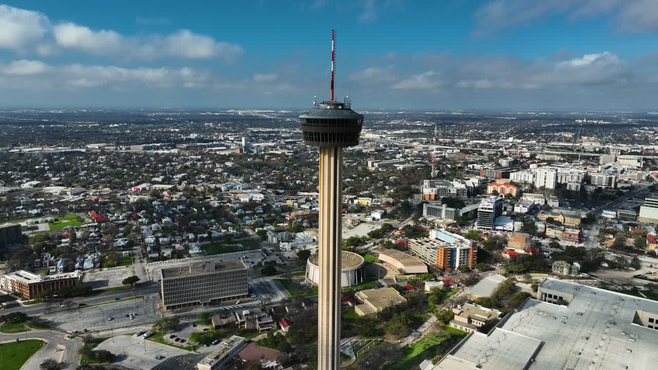Panoramic drone shot circling the Tower of the Americas, in sunny San Antonio