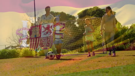 animación de la bandera de españa sobre una familia caucásica jugando al fútbol