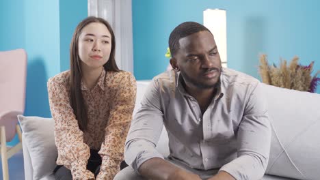 african young man offended at his asian girlfriend.