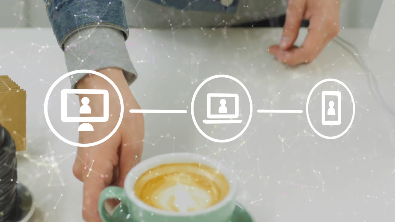 Man reaching toward green latte cup on bright tabletop in technology demo, showing network icons