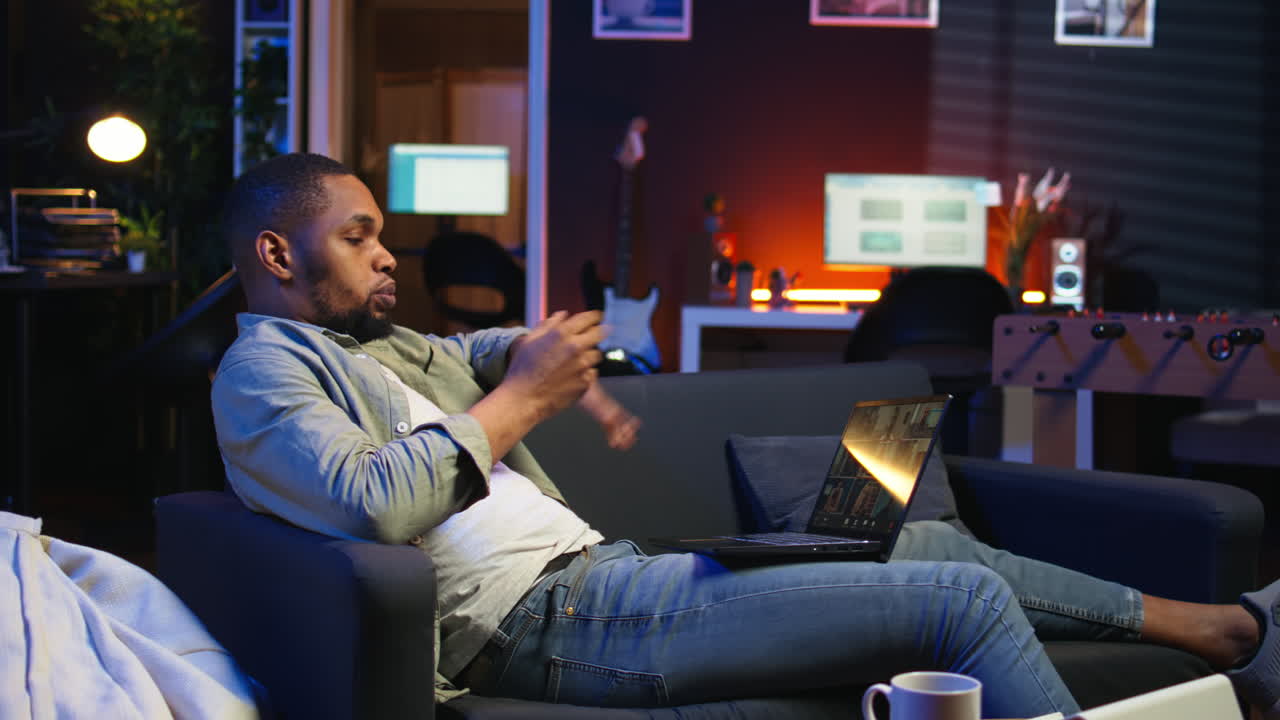 Vertical Video Smiling african american man hosting a virtual family meeting online