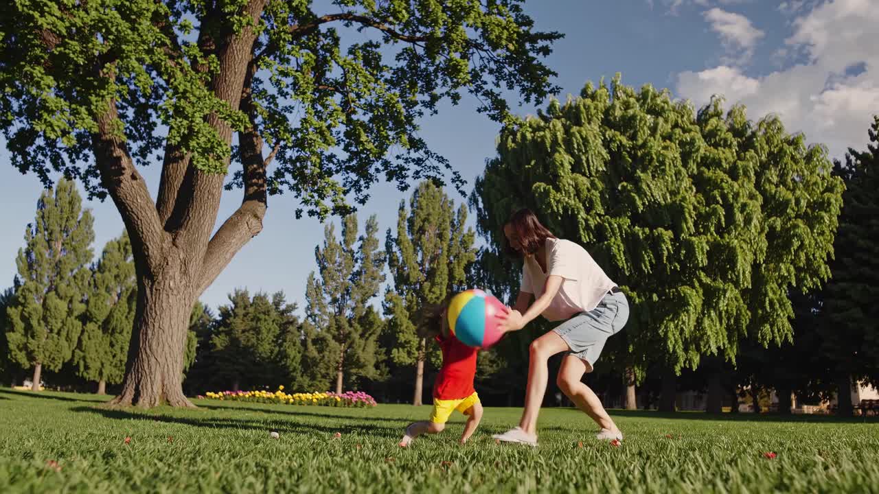 Mother and Child Playing Ball in a Park