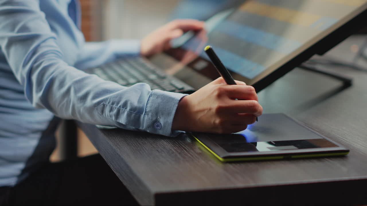 Female photographer working as retoucher with tablet and stylus pen