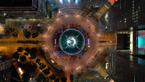 night illumination flight over singapore city famous downtown traffic circle aerial topdown panorama 4k