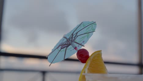 Close-up-shot-of-cherry-and-orange-on-an-umbrella-stick