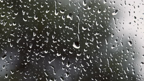 Rain-drops-on-a-window-after-a-summer-storm-in-Worcestershire,-England