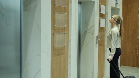 businesswoman waiting for elevator