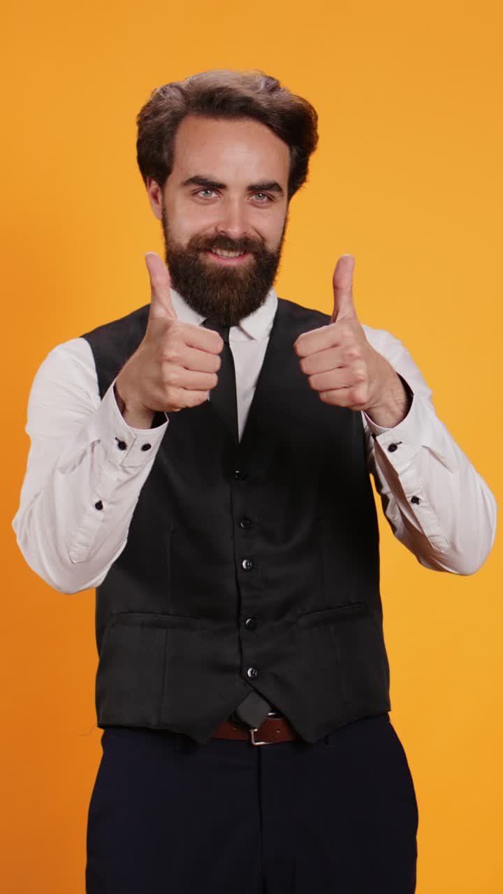 Vertical video Satisfied waiter does positive gesture
