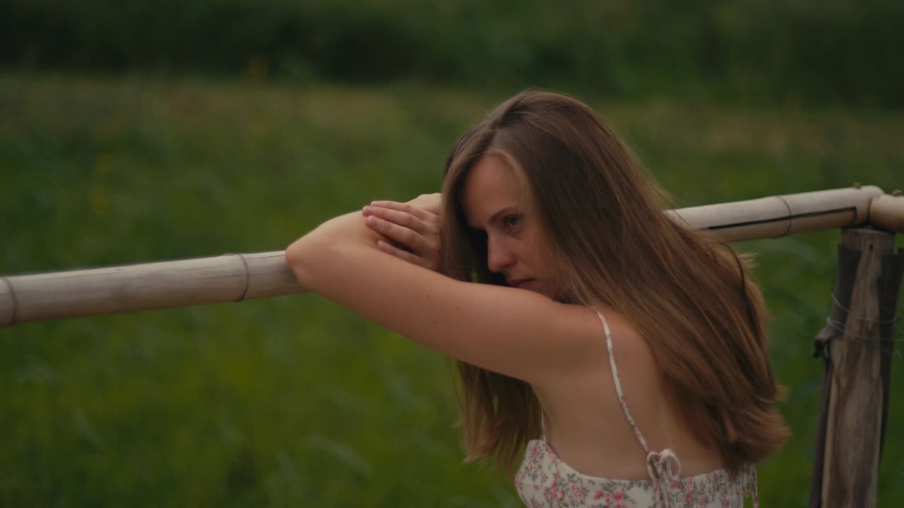Woman by Bamboo Fence