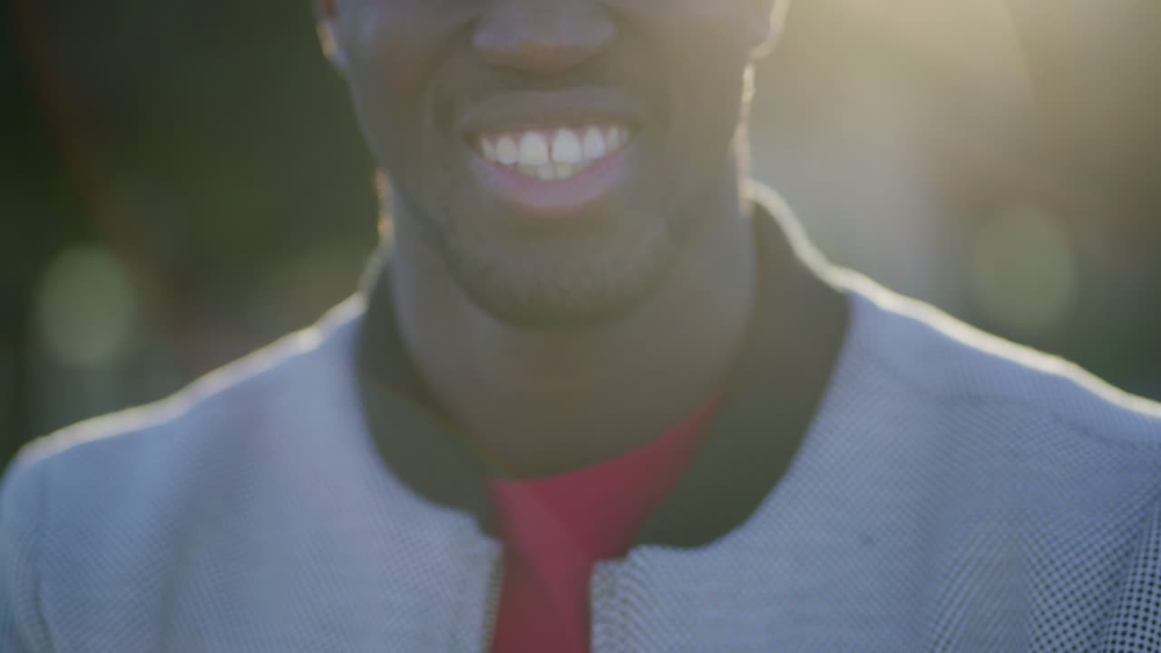 Close-up shot of young Afro-American male mouth smiling