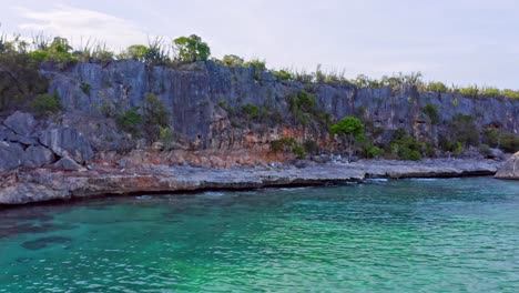 Aerial-view-of-rocky-coast-with-cliffs-and-shore-with-turquoise-water-of-Caribbean-Sea