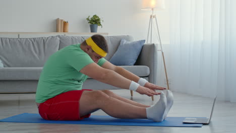 overweight man doing stretching exercises at home