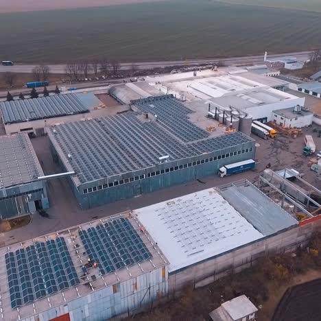 solar farm on the roofs of buildings. rooftops with many sunny batteries for receiving clean energy from sun. aerial view.
