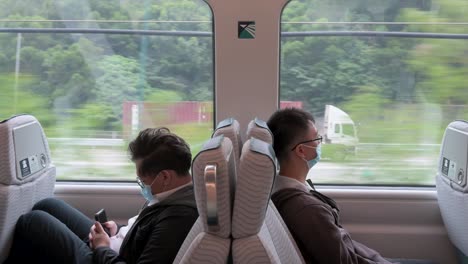 passengers ride on the mtr express train with the destination to hong kong international airport