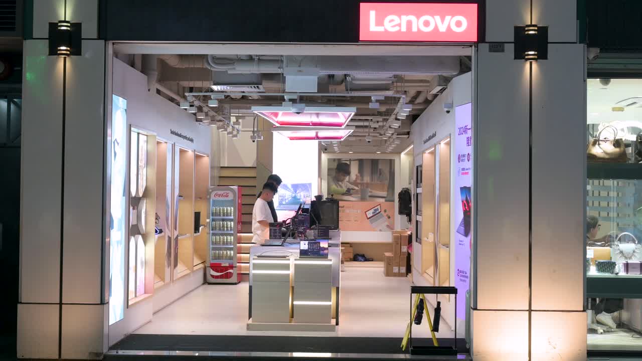Chinese customers are seen at a Lenovo store, the Chinese multinational technology company, at night.