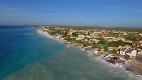 big waves damaging houses after a hurricane passed by at the coastline of bonaire