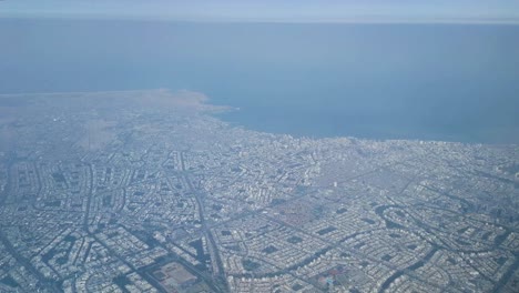 Aerial-view-out-of-arrival-airplane-window-of-smoggy-Lima-city-in-Peru