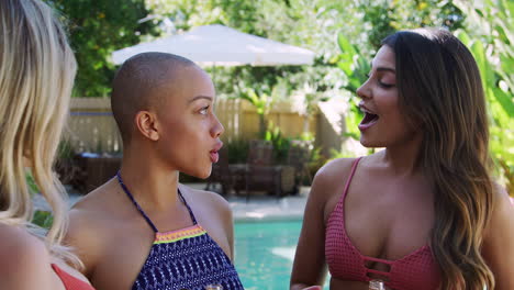 Group-Of-Female-Friends-Outdoors-Drinking-Beer-And-Making-Toast-As-They-Enjoy-Summer-Pool-Party