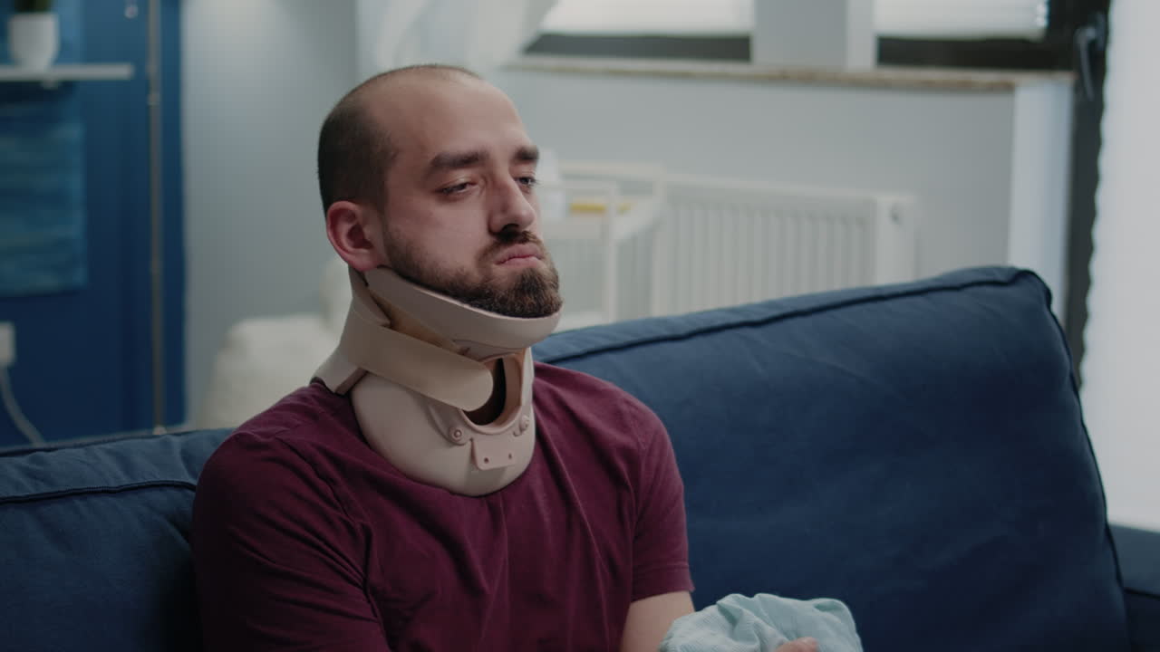 Person sitting with cervical neck foam after muscle injury