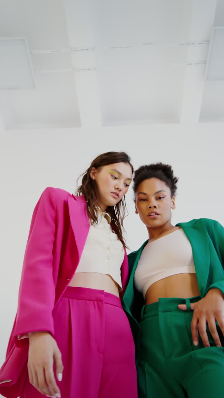 Two Stylish Women in Pink and Green Blazers