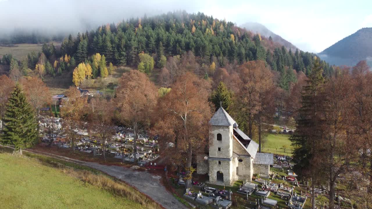 Witness the tranquility of a historic cemetery, its peaceful grounds adorned with a quaint chapel that stands as a testament to the village's rich heritage.  Located in Slovakia, Eastern Europe