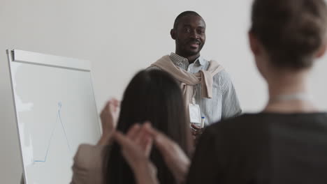 people applauding african businessman