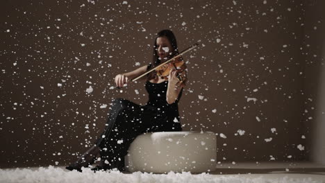 violinist playing in a winter scene