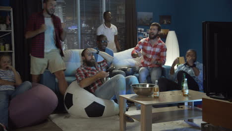 friends watching a game at home